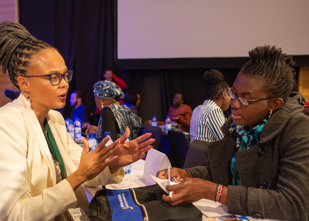 Two delegates in discussion during an ATPSA business session
